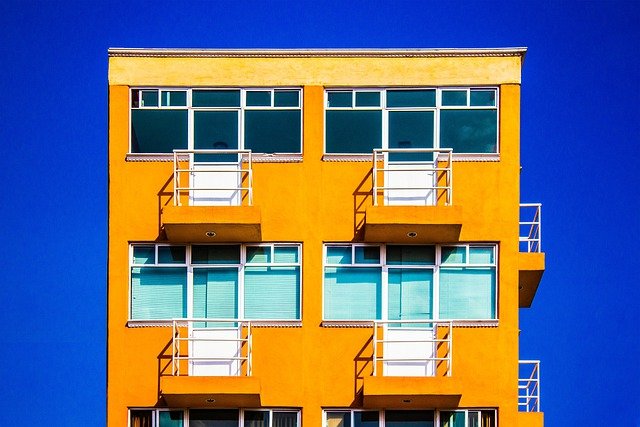 orange apartment against blue sky